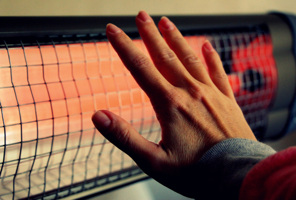 right hand in front of infrared heater